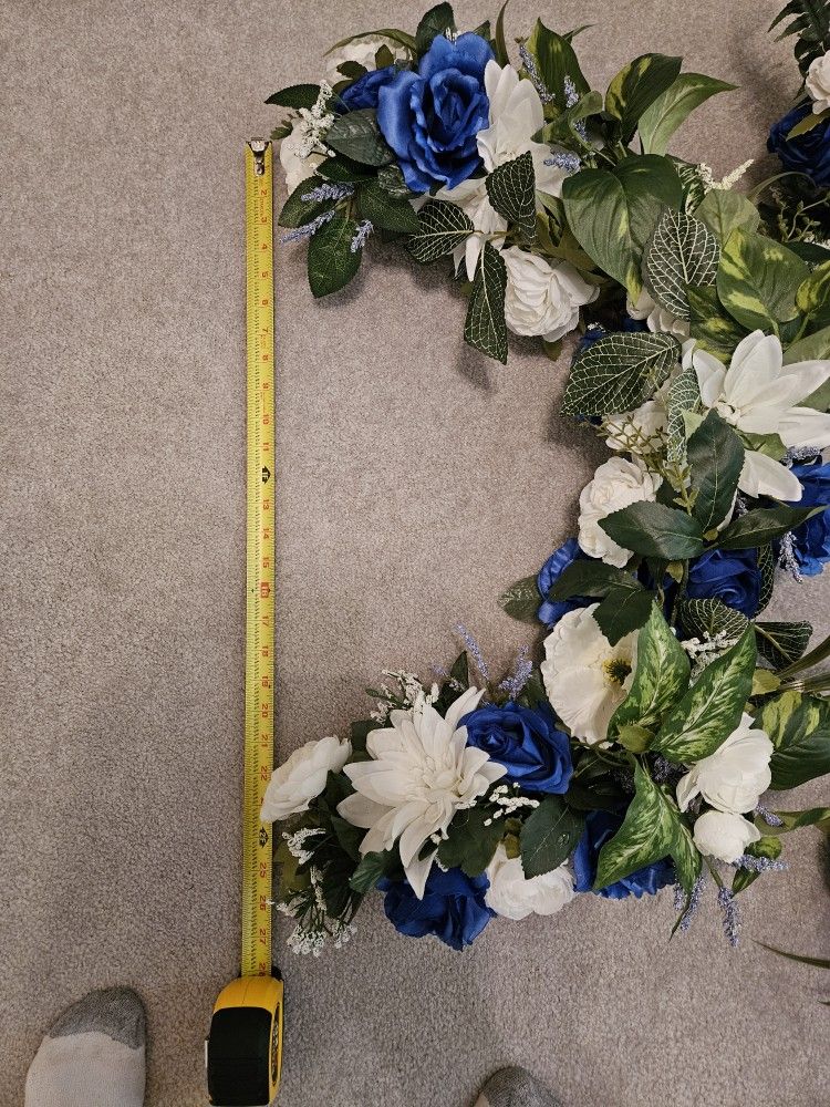 2 Half Moon Flower Arrangement With Light Blue And Dark Blue Flowers On Grape Wreath