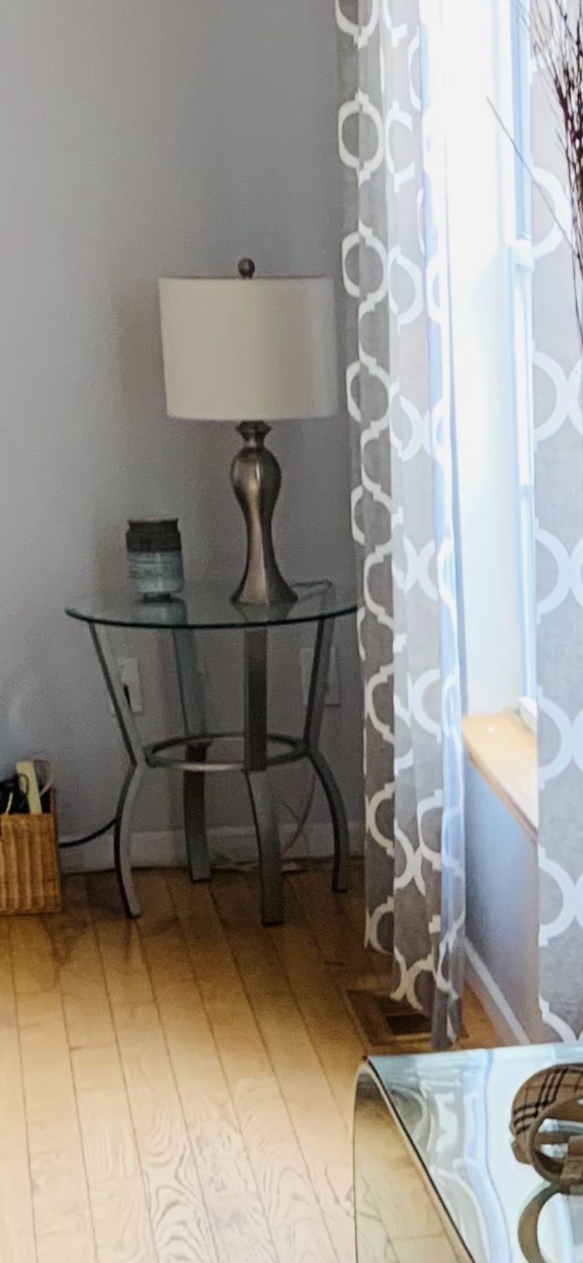 End table, Glass Top And Gray Metal Legs. Very Chic!