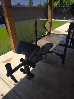 Weight bench, with bench bar.  Its a good beginning bench, padding is fade.
