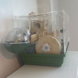 Hamster cage with hamster and food included.