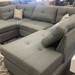New Reversible Nailhead Sectional.  Grey.  104” X 75”.  Free Delivery!