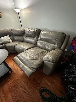 Grey sectional seats seven little bit of damage from a little dog no cats, easily washable cleanable, and comes with remote recline Grey sectional sea