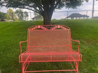 Coral wrought iron glider bench