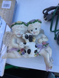 Musical angel box hangs over side of table