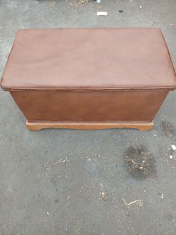 Vintage trunk with leather around the outside and soild wood underneath the leather