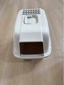 white Van Ness enclosed cat litter pan with a top carrying handle