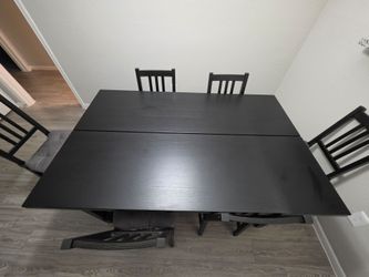Ikea black table extender with 6 chairs