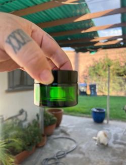 Lot of 10 green glass jars 1 oz