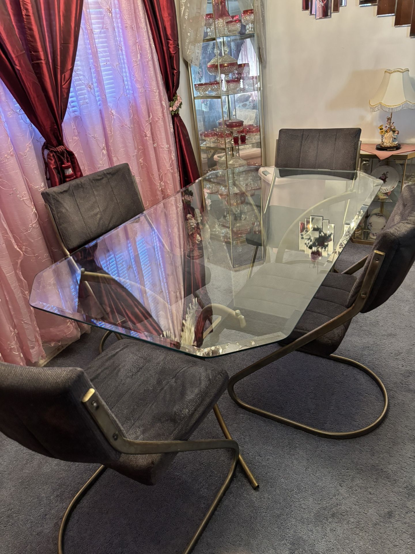 Glass dining room table with four chairs