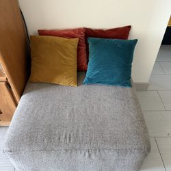 Grey Ottoman + Multi Colored Throw Pillows