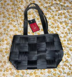 Durable woven seatbelt material bag in black and charcoal grey. This Harveys tote has a black fabric interior lining with a zippered pocket and a magn