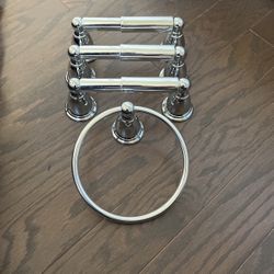 Three Moen Toilet Paper Holders And One Towel Holder