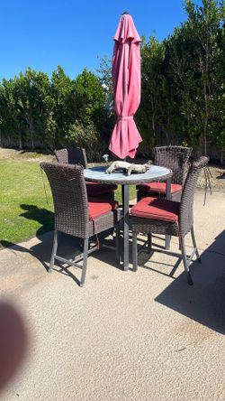 Table, Chairs And Umbrella. 