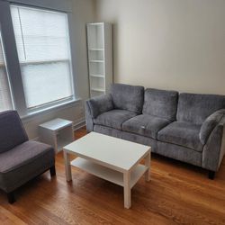 Blue Couch and white Bookshelf And Table