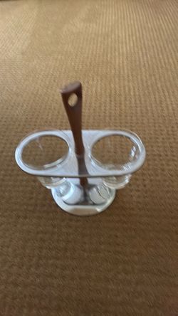 2 glass containers held by chrome base and portable by wooden handle