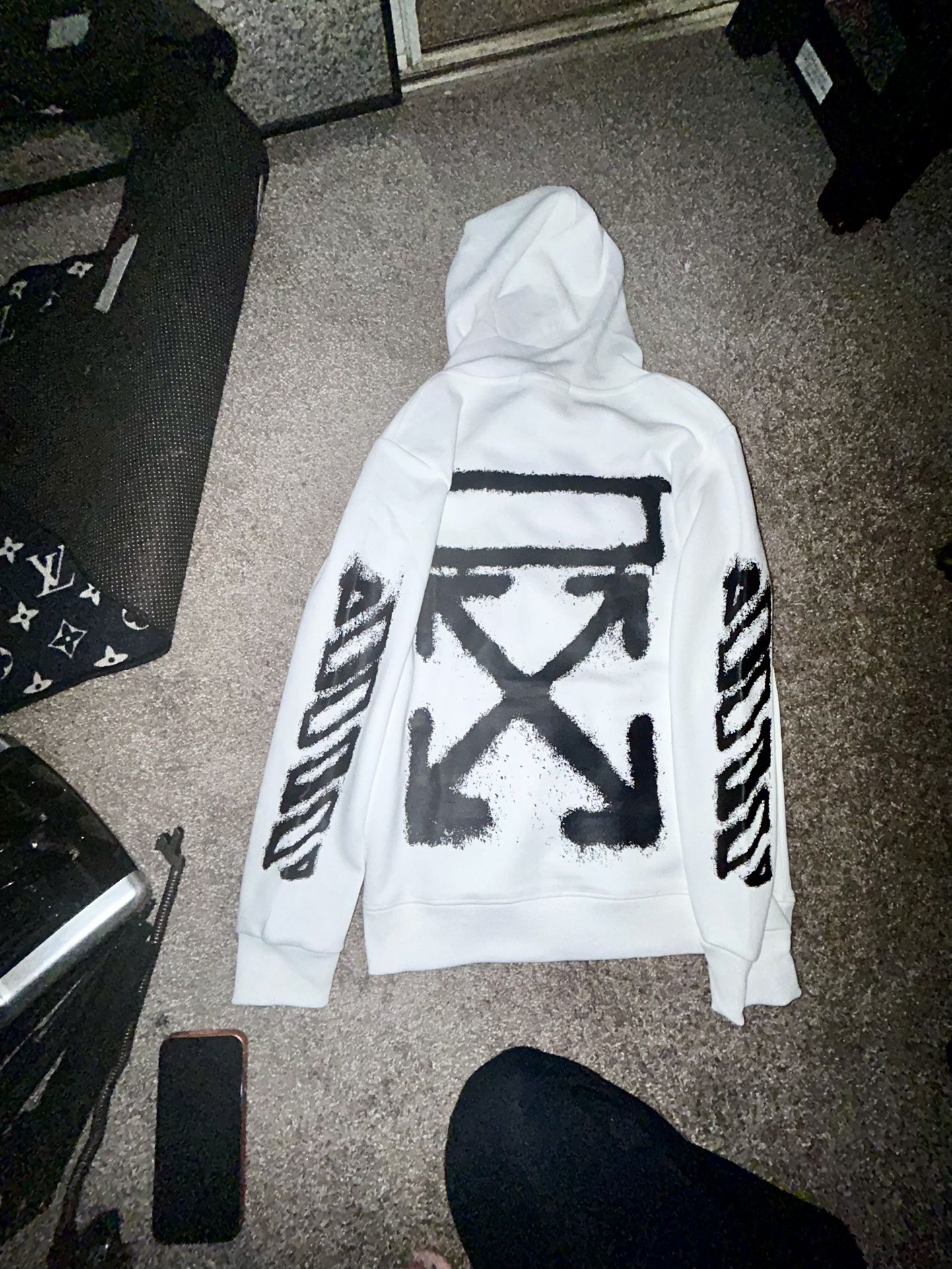 Authentic Off-White™ hoodie featuring the iconic black arrow spray design on the back, striped sleeves, and the signature “Off” hand logo on the chest