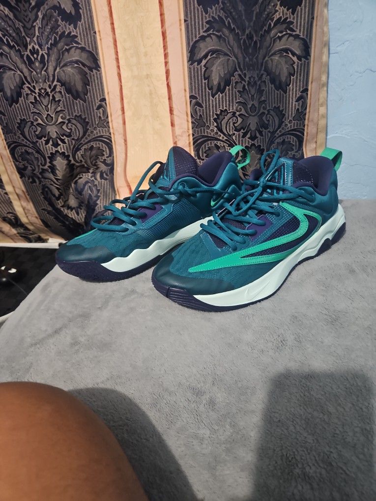 The Nike Giannis Immortality 3 basketball shoes green teal purple size 10.5