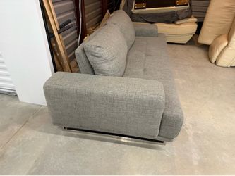 Grey love seat with adjustable head rest