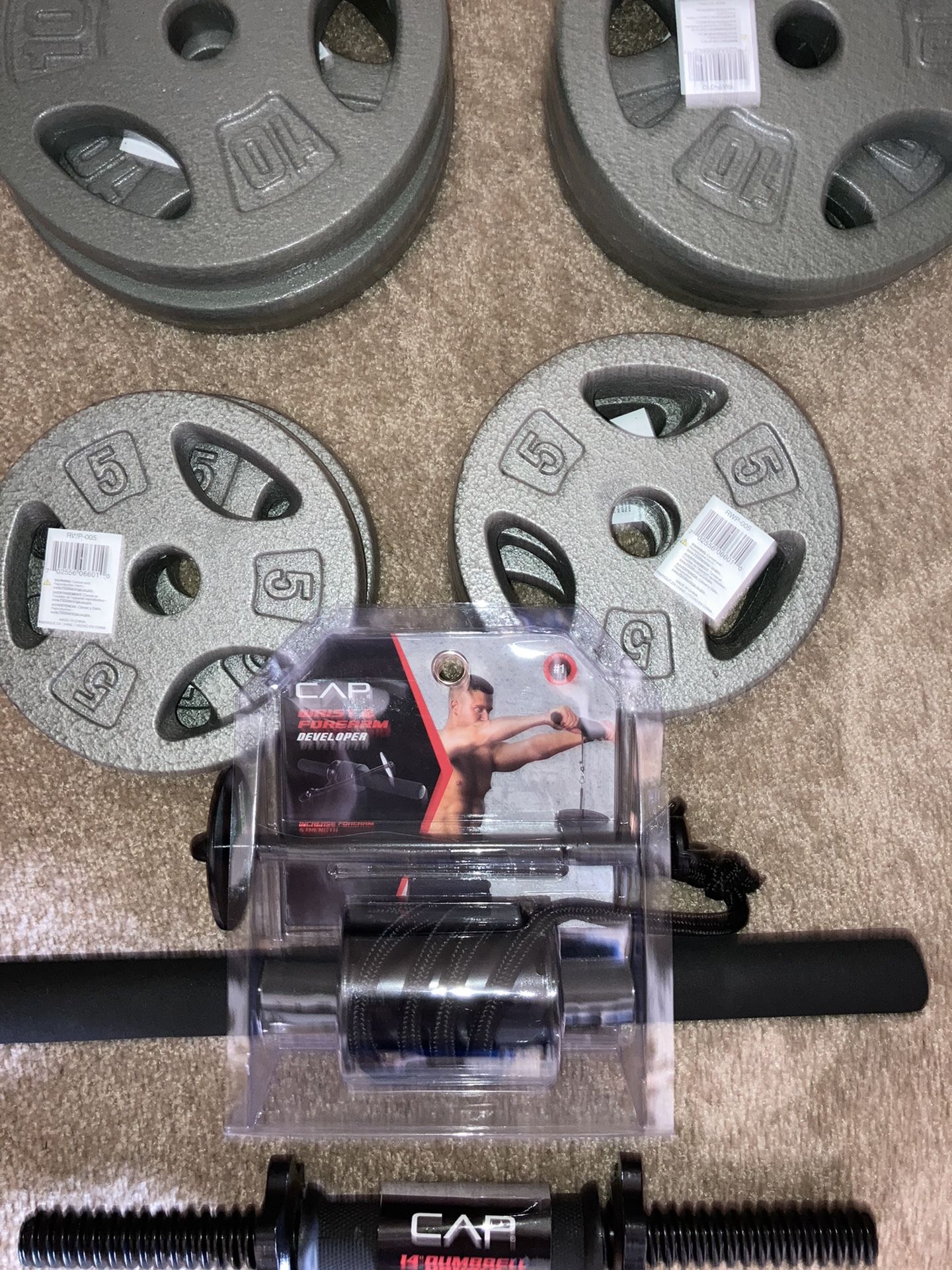 5 and 10 pound plates with Dumbbell handle and Wrist and forearm developer