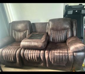 reclining sofa with center console & cup holders.
