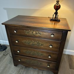 Four drawer Lambert Hitchcock dresser with stenciling on the drawers and eagle knobs.
