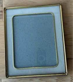 Vintage metal frame with decorative edges and gold rimed mat, 10”X12”.
