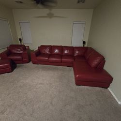 Red leather sectional with chair and ottoman