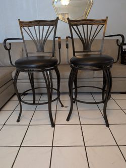 Sturdy metal swivel bar stools with dark brown faux leather