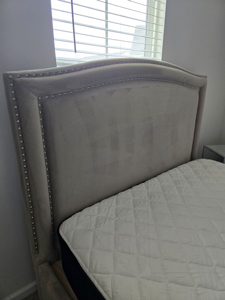 bed, beige upholstered, and glass nightstand.