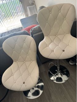 White cushioned bar stools