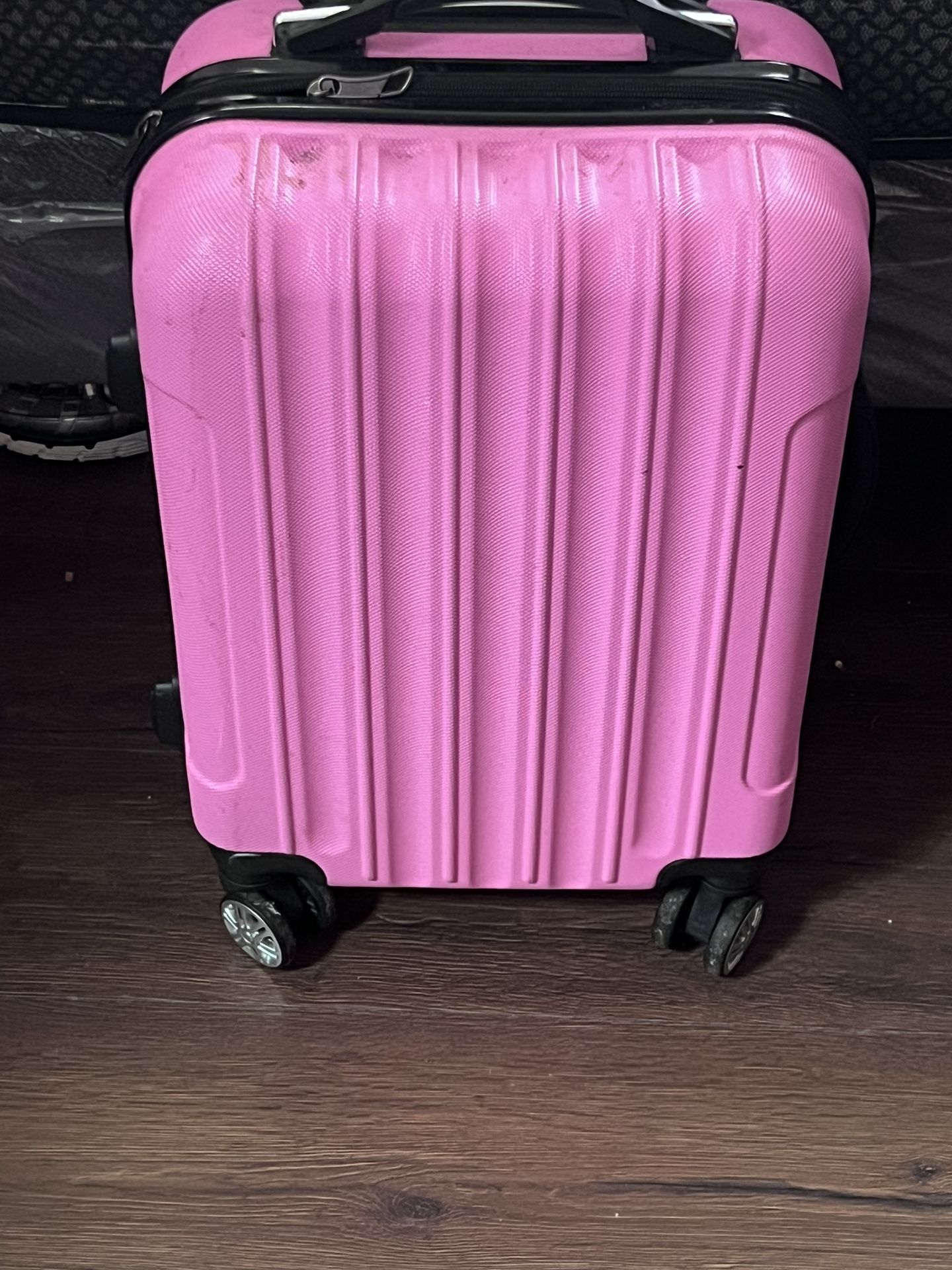 Pink hard-shell suitcase with four spinner wheels