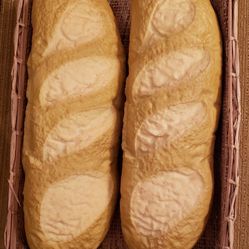 These look so real..Staging props...2 rubber loaves of bread 14x4x3 in basket 15x10x3.