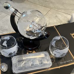 Whiskey decanter set with glasses.  Globe with Ship in a bottle.