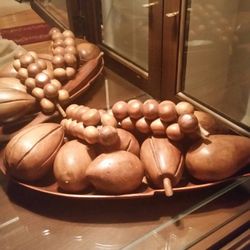 Vintage carved wooden fruit in wooden pod leaf