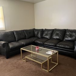 Black leather sectional & Gold Glass Table.