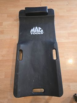 Mac Tools plastic Tools creeper featuring padded headrest and handles
