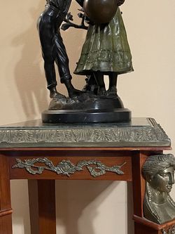 Antique Bronze Statue On A Table 