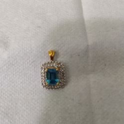 Beautiful emerald cut blue topaz and diamond pendant in 10k gold