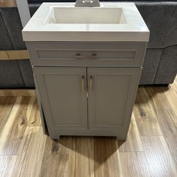 24 Inch Bathroom Vanity With A Sink And Faucet