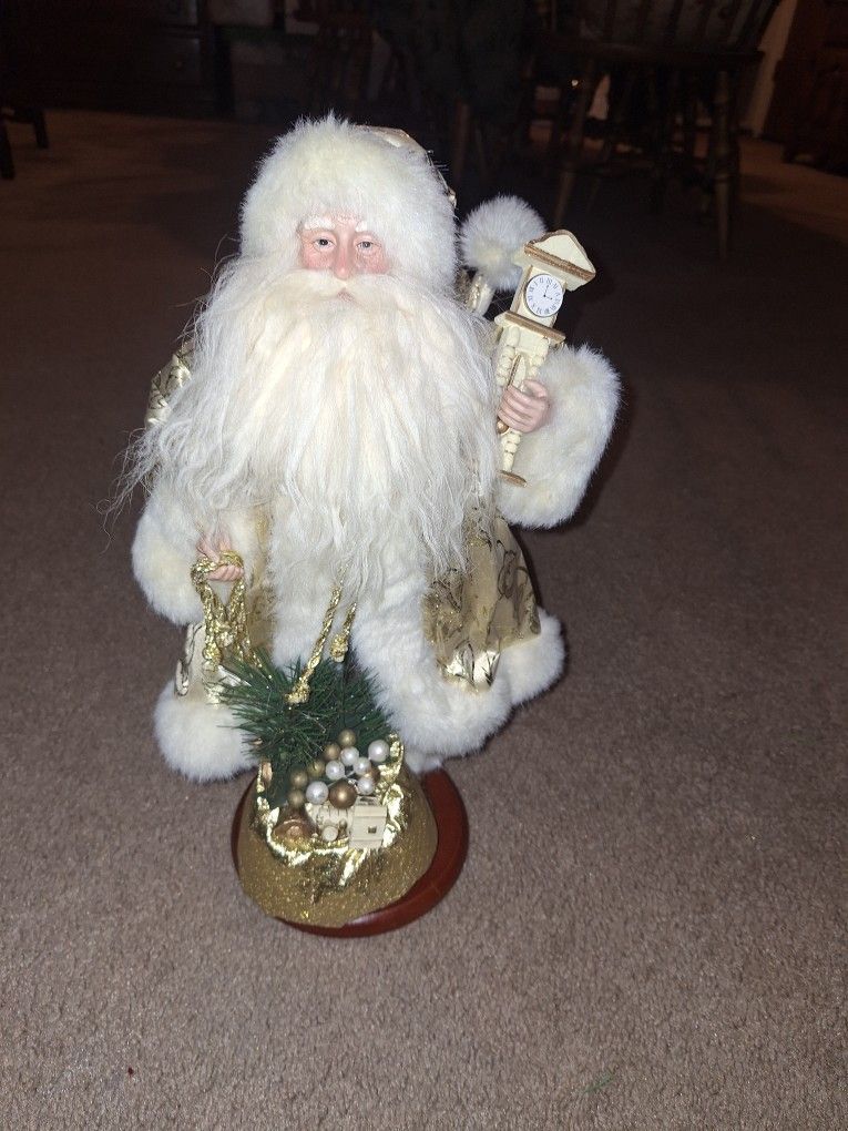 Santa Dressed in Gold holding a Clock & Toy Bag