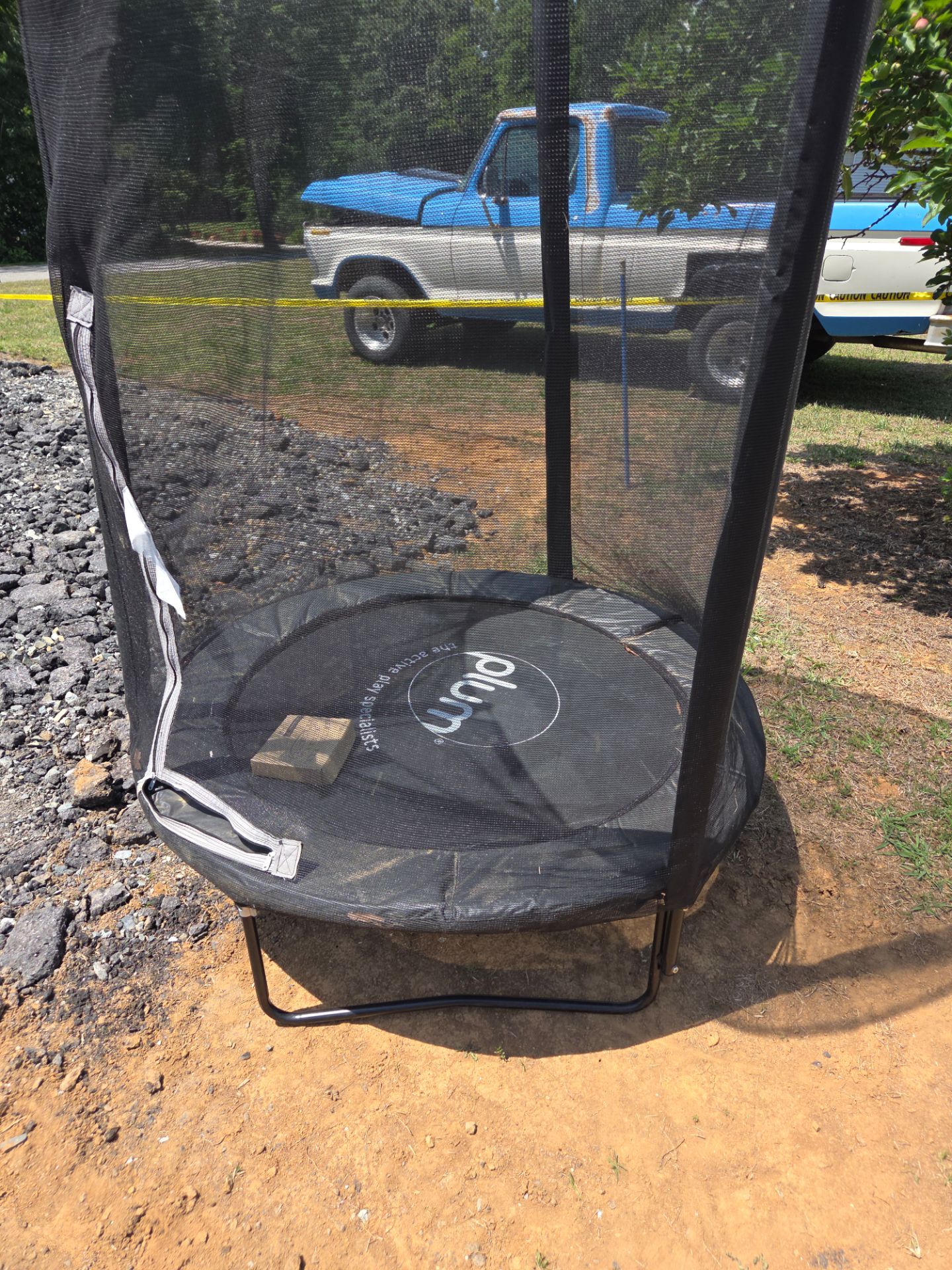 Plum Play 4.5' Interactive Junior Trampoline with Enclosure and Lights in black.