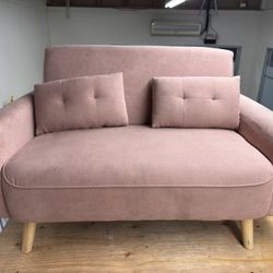 Pink two-seater upholstered sofa with two cushions – 70"