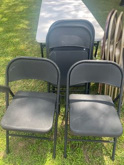 5 black folding chairs