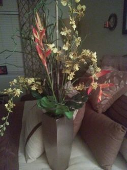 Artificial flower arrangement in shiny vase