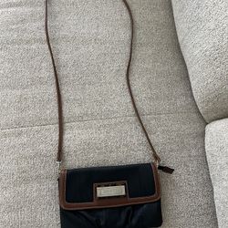 Chaps black faux leather crossbody bag with brown trim and a flap closure.