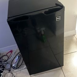 RCA compact refrigerator, likely a single-door model in black. 