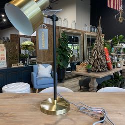 {ONE} Hayden Adjustable Metal Desk Lamp. Overall: 22.5'' H X 8'' W X 14'' D. Finish: gold/black. MSRP: $135. Our price: $72 + Sales tax