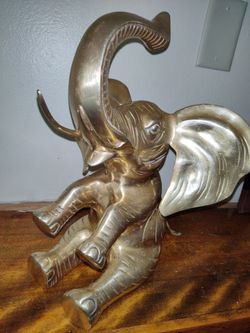 This is a vintage solid brass elephant statue,