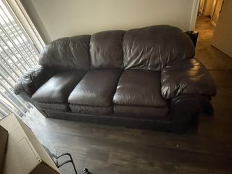 Brown Leather Couch And Love Seat. With 2small And 1 Big Table