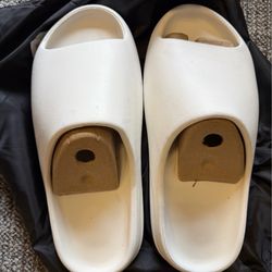New. White Yeezy slide. Size 10. Some markings